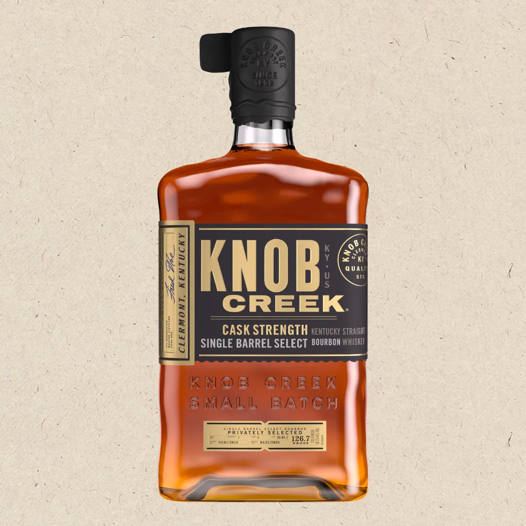 A bottle of Knob Creek bourbon whiskey, showcasing its distinctive label and rich amber color.